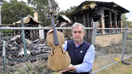 Phil Morley, president of Wyong District Museum and Historical Society, with the Coo-ee violin saved from the deliberately-lit fire that came close to completely destroying Alison Homestead in 2011. Picture: Troy Snook Source: NewsLocal